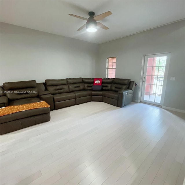 living room with ceiling fan and light hardwood / wood-style flooring