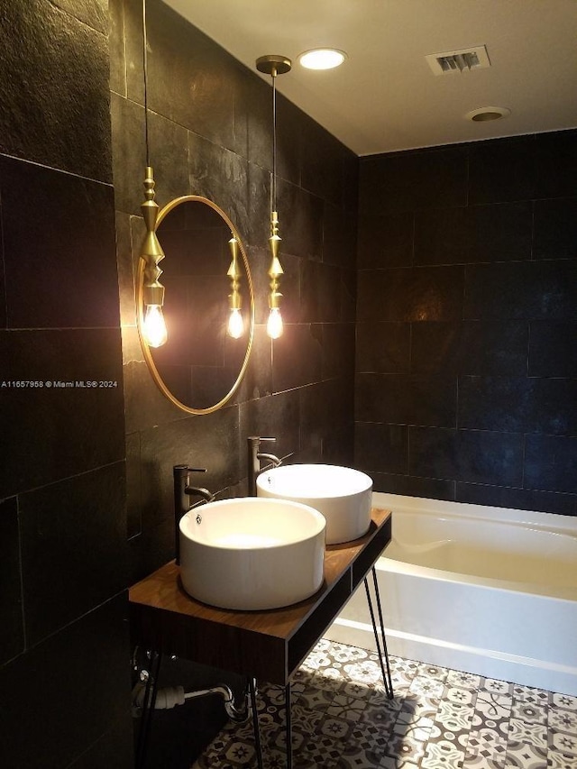 bathroom with vanity and tile walls