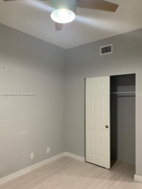 unfurnished bedroom featuring a closet and light hardwood / wood-style floors