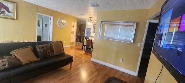 living room with hardwood / wood-style flooring and a textured ceiling