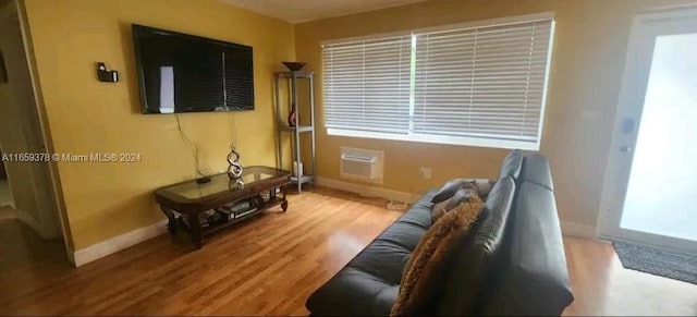 interior space with a wall unit AC and hardwood / wood-style flooring