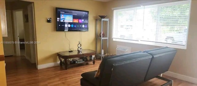 living room featuring a wealth of natural light and hardwood / wood-style floors