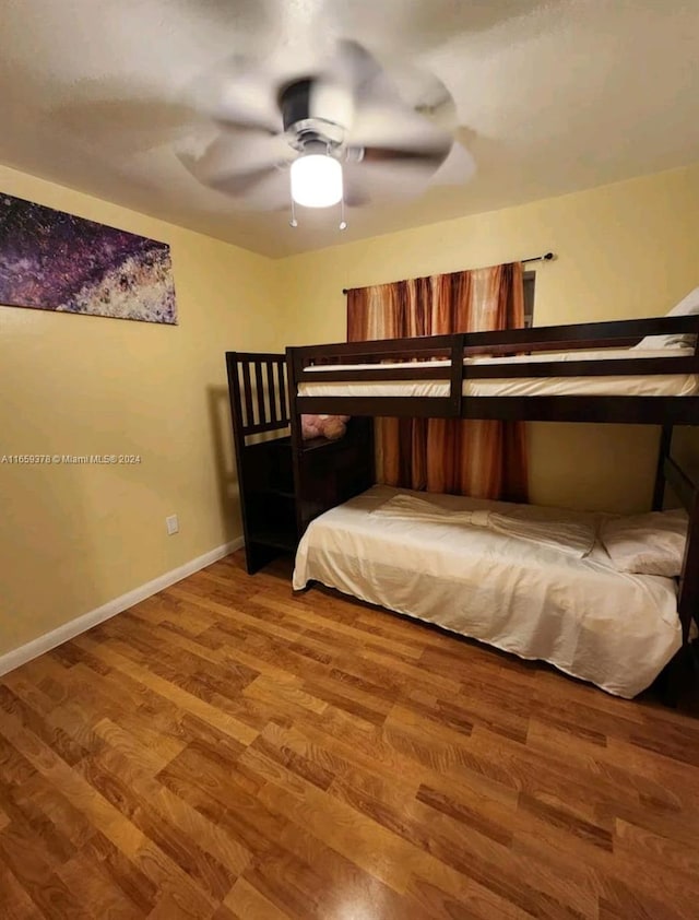 bedroom featuring wood-type flooring and ceiling fan