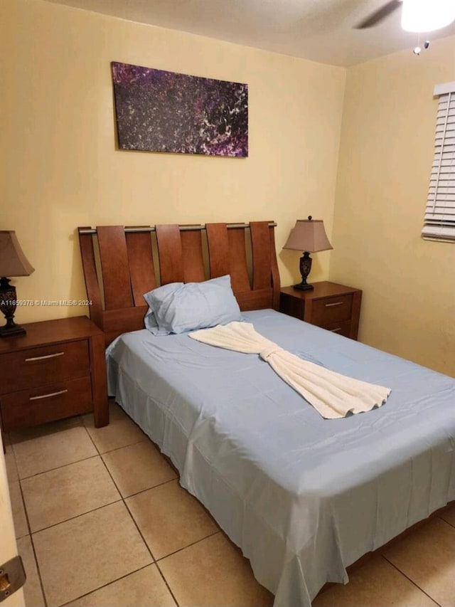 tiled bedroom with ceiling fan