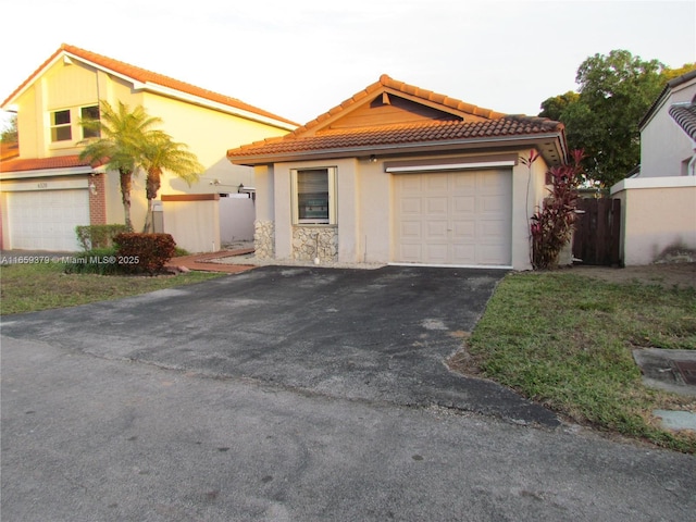 mediterranean / spanish-style house with a garage