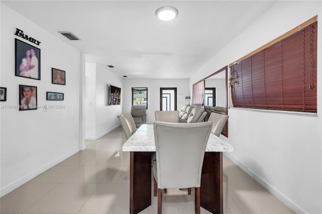 dining space with light tile patterned flooring