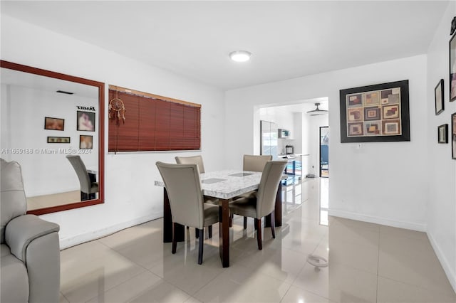 dining space featuring light tile patterned flooring