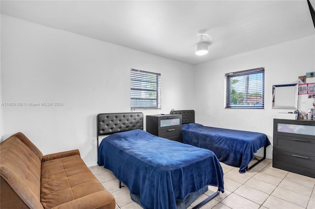 tiled bedroom with multiple windows