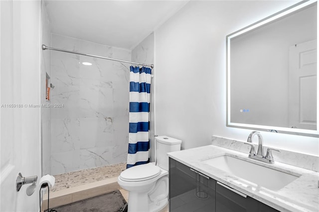 bathroom featuring vanity, toilet, and a shower with shower curtain