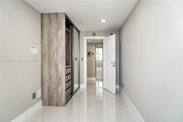 hallway featuring light tile patterned floors