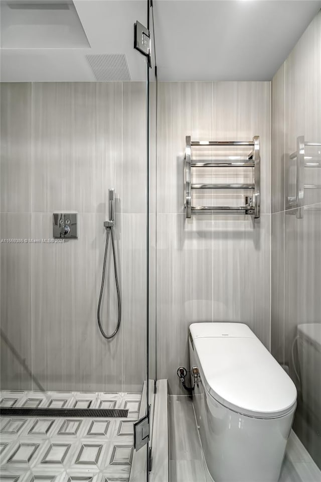 bathroom featuring radiator, toilet, and a shower