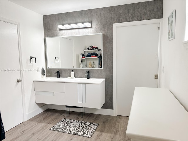 bathroom with hardwood / wood-style flooring and vanity