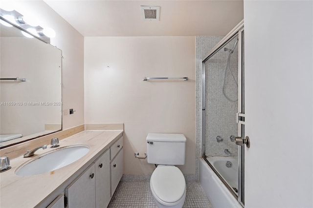 full bathroom with tile patterned floors, vanity, toilet, and combined bath / shower with glass door