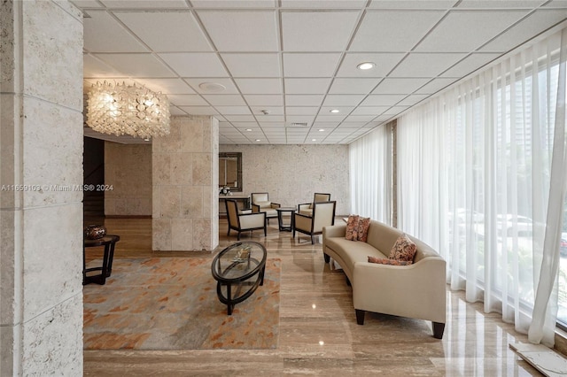 living room with a paneled ceiling and hardwood / wood-style flooring