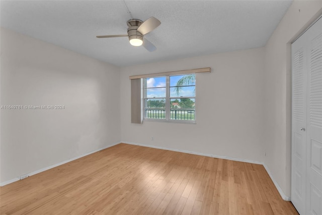 unfurnished bedroom with light wood-type flooring, a closet, and ceiling fan