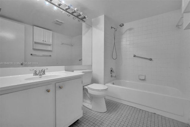 full bathroom with tiled shower / bath combo, vanity, toilet, and tile patterned flooring