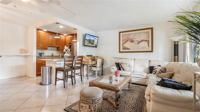 tiled living room with ceiling fan