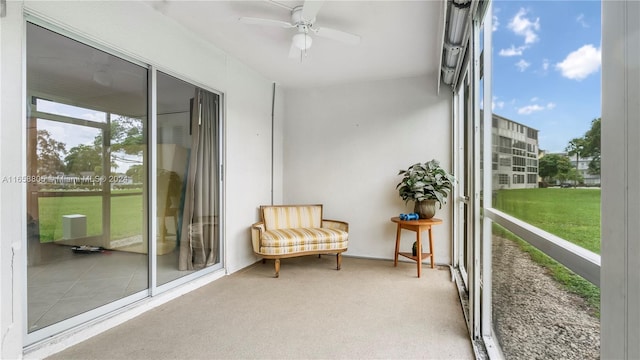 sunroom featuring ceiling fan