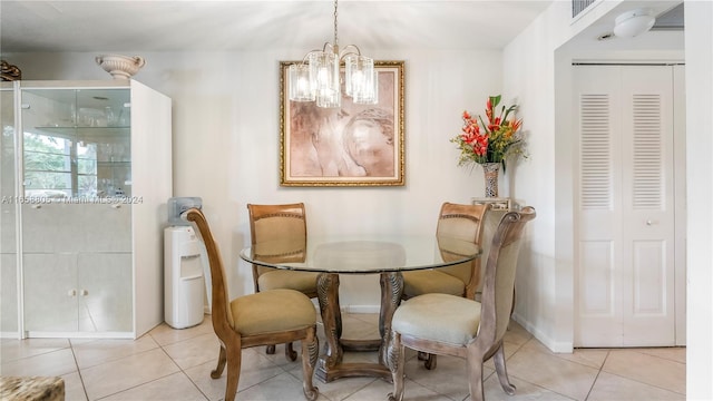 dining area featuring a notable chandelier and light tile patterned flooring