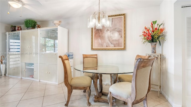 tiled dining area featuring ceiling fan with notable chandelier