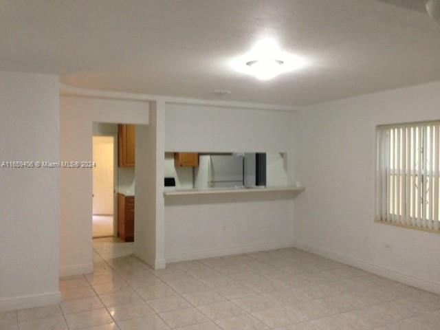 empty room with light tile patterned floors