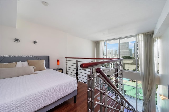 bedroom featuring access to outside and hardwood / wood-style floors