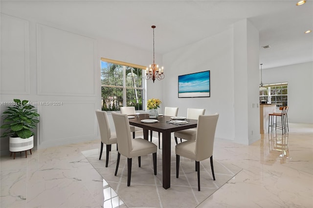 dining space with a chandelier