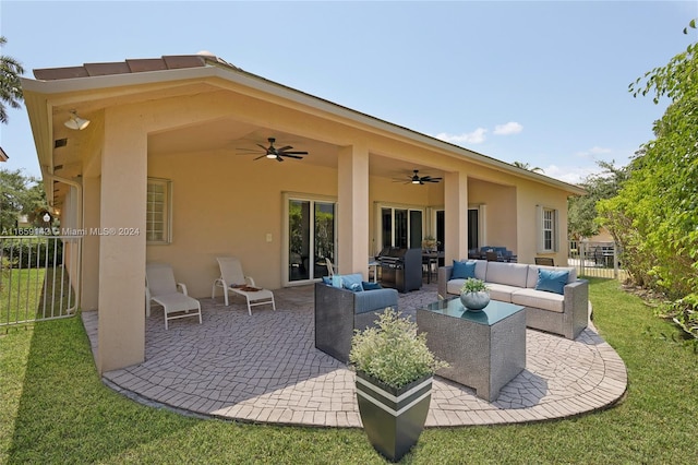 back of house featuring a patio, a yard, outdoor lounge area, and ceiling fan