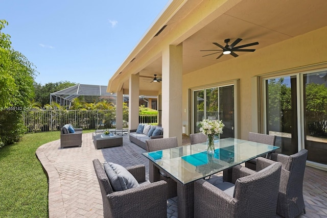 view of patio / terrace with an outdoor living space, a lanai, and ceiling fan