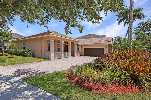 ranch-style home with a garage and a front yard