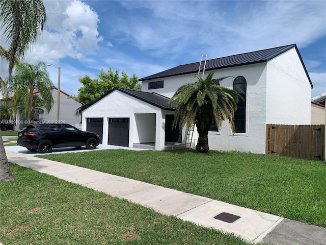 view of front of home with a garage and a front yard