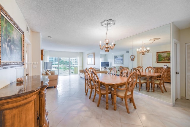 tiled dining room featuring a notable chandelier and a textured ceiling