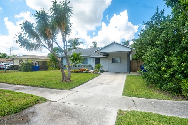 ranch-style home featuring a front lawn and a carport