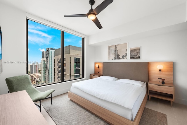 tiled bedroom featuring ceiling fan