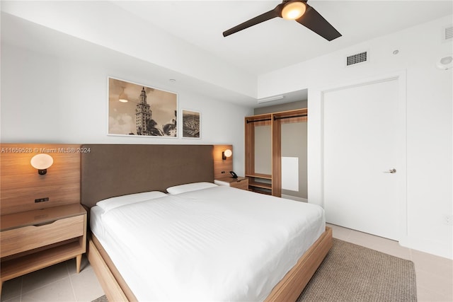 bedroom with a closet, ceiling fan, and light tile patterned floors