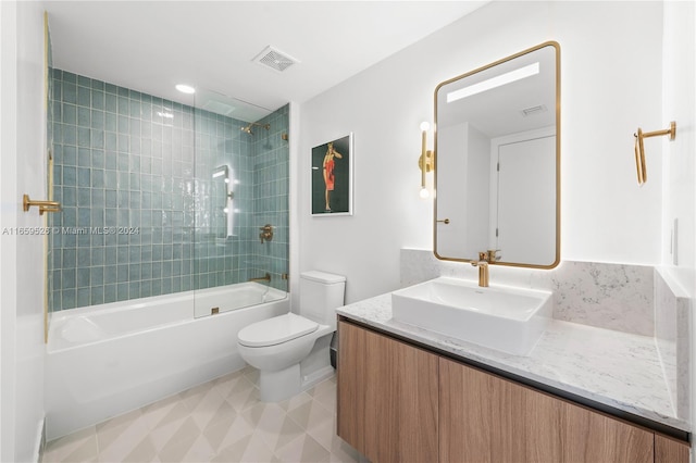 full bathroom featuring vanity, toilet, and tiled shower / bath combo