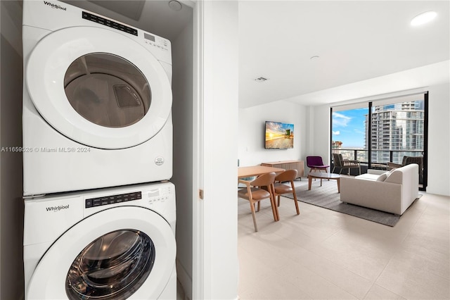 washroom featuring stacked washer / dryer