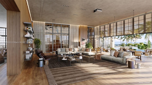 living room featuring wood-type flooring, floor to ceiling windows, and a high ceiling