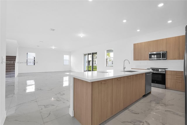 12267 SW 43rd Ct, Davie, FL 33330 - kitchen featuring stainless steel appliances, light marble finish floors, an island with sink, open floor plan, and recessed lighting