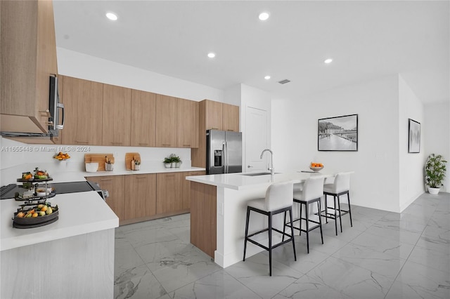 12267 SW 43rd Ct, Davie, FL 33330 - kitchen featuring stainless steel fridge with ice dispenser, light marble finish flooring, a breakfast bar area, modern cabinets, and recessed lighting
