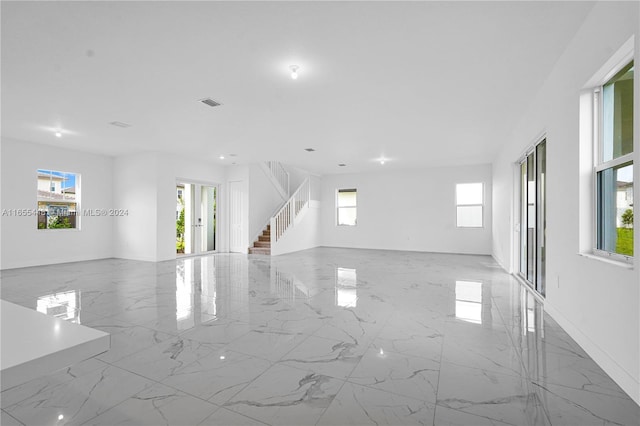 12267 SW 43rd Ct, Davie, FL 33330 - empty room featuring plenty of natural light, marble finish flooring, stairway, and recessed lighting