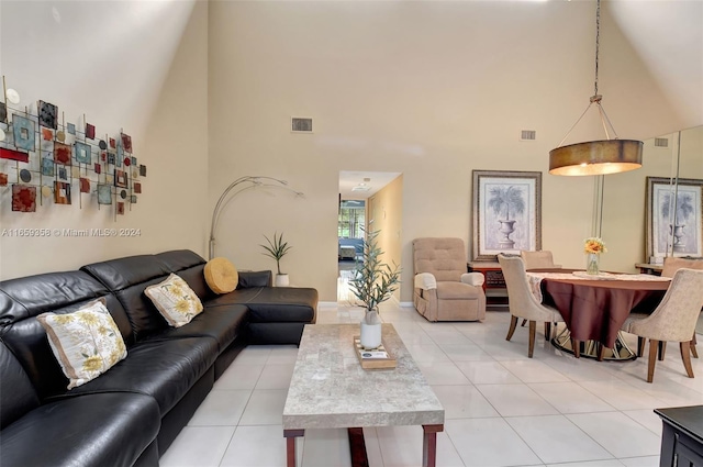 living room featuring high vaulted ceiling and light tile patterned floors