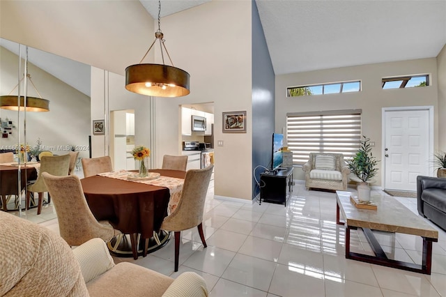 tiled dining area with high vaulted ceiling