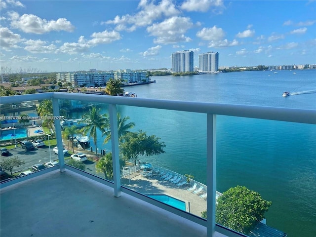 balcony featuring a city view and a water view