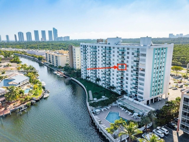 drone / aerial view featuring a city view and a water view