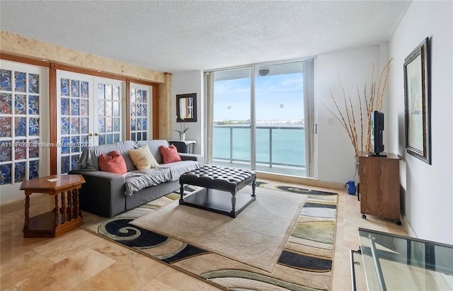 living room featuring a textured ceiling and expansive windows