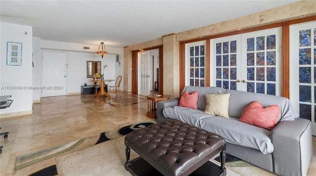 living room featuring a textured ceiling and french doors