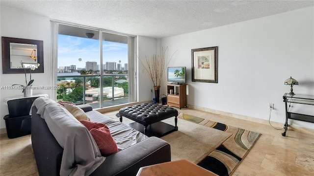 living room featuring a textured ceiling and a wall of windows