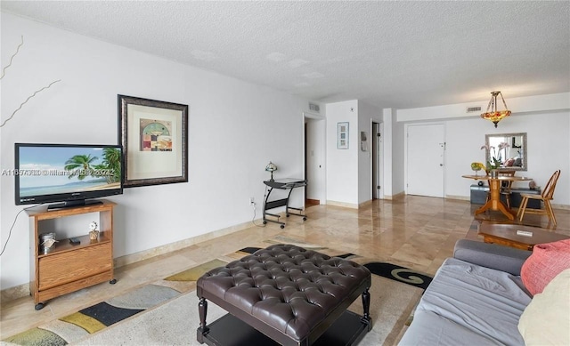 living room with a textured ceiling and visible vents