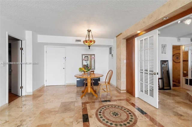 dining room with a textured ceiling